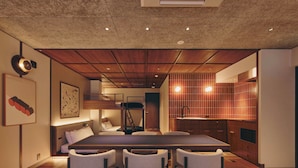 A modern kitchen with wooden cabinets, a built-in oven, and a sink. - illi Nuto Shinjuku (Tokyo)