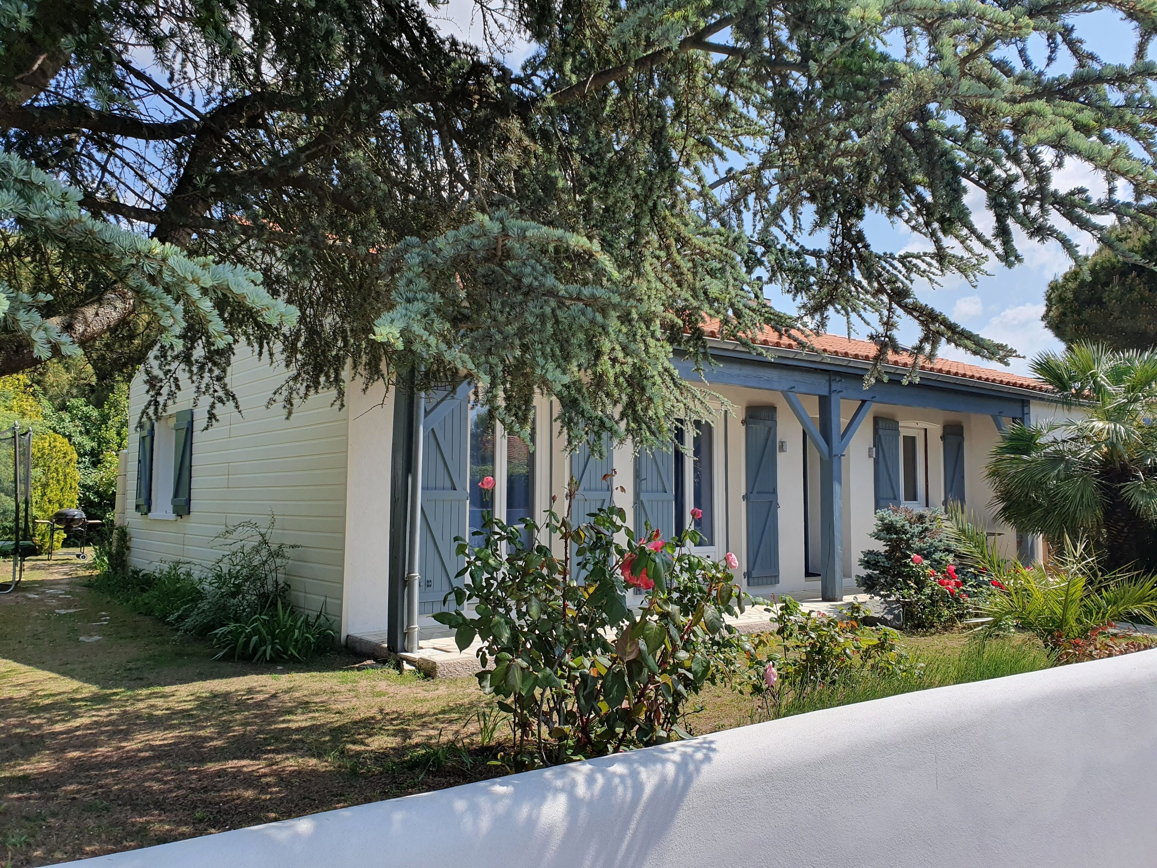 A house with a porch, a garage, and a garden.