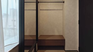 A room with a wooden bench, a black metal railing, and a view through a window. - illi Haku Asakusa (Tokyo)