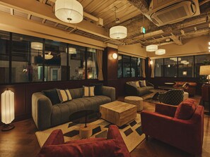 A modern interior with a sofa, armchairs, and a coffee table. - illi Haku Asakusa (Tokyo)