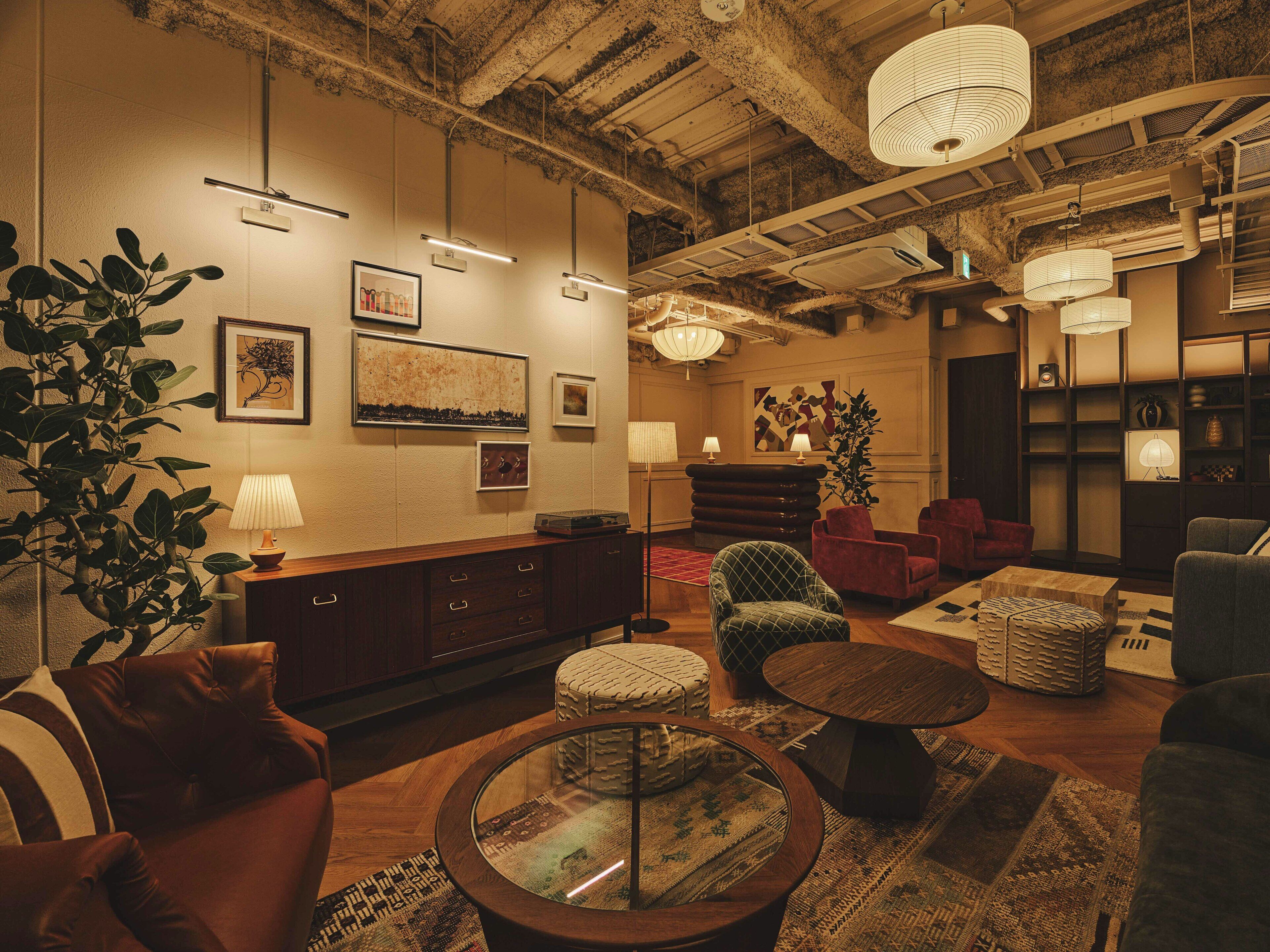 A cozy lounge area with a wooden coffee table, cushioned seating, and a large plant.