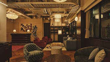 Un área de descanso con asientos, una mesa de centro y una estantería.