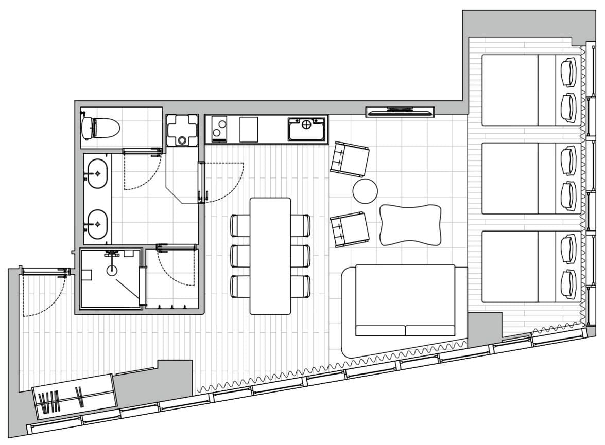 Un plan d’aménagement de chambre d’hôtel comprenant un lit, un coin salon et une kitchenette.