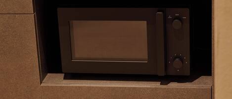 A microwave oven built into a cabinet with a control panel on the right side.