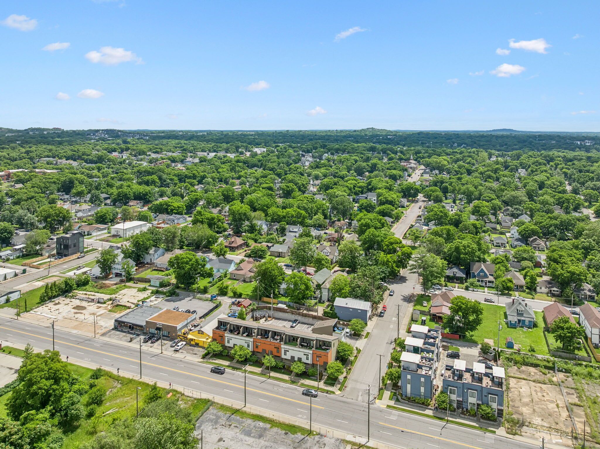 An aerial view of a residential area with houses, streets, and a mix of commercial buildings.
