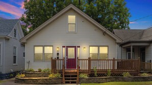 A two-story house with a front porch, a red door, and a number 305 on the front wall. - Spacious family-friendly home w/ exclusive arcade! (New Albany)