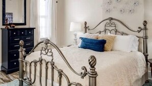 A bedroom with a bed, a dresser, and a nightstand. - Modern apartment near Nulu and other attractions! (Louisville)