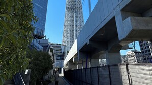 A modern building with a glass facade and a metal tower structure. - 3-101: Newly built Apt, 2 min sta., Near Skytree & Asakusa (Sumida City)