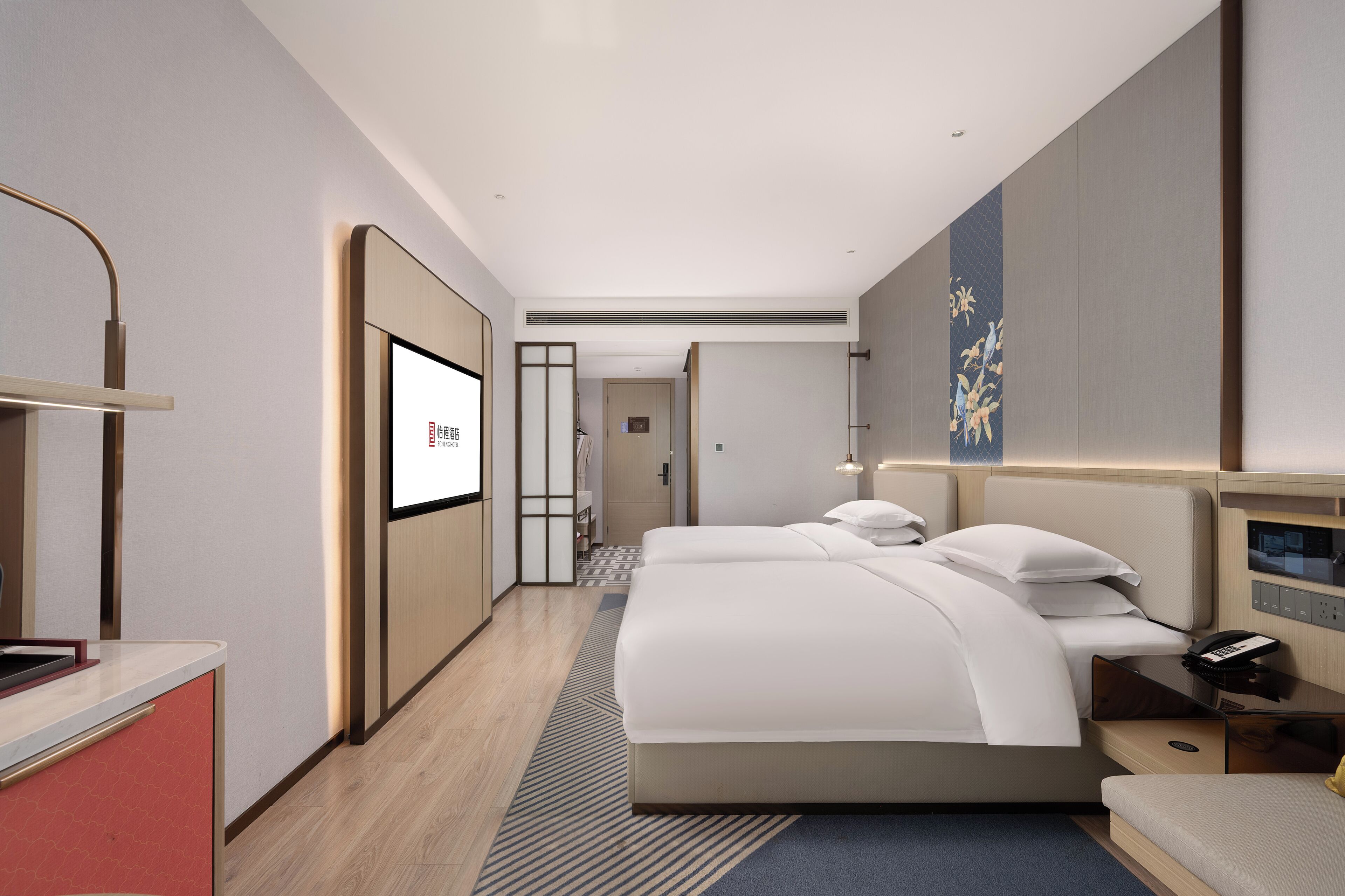 A modern hotel room with a large bed, bedside tables, a desk, and a TV.