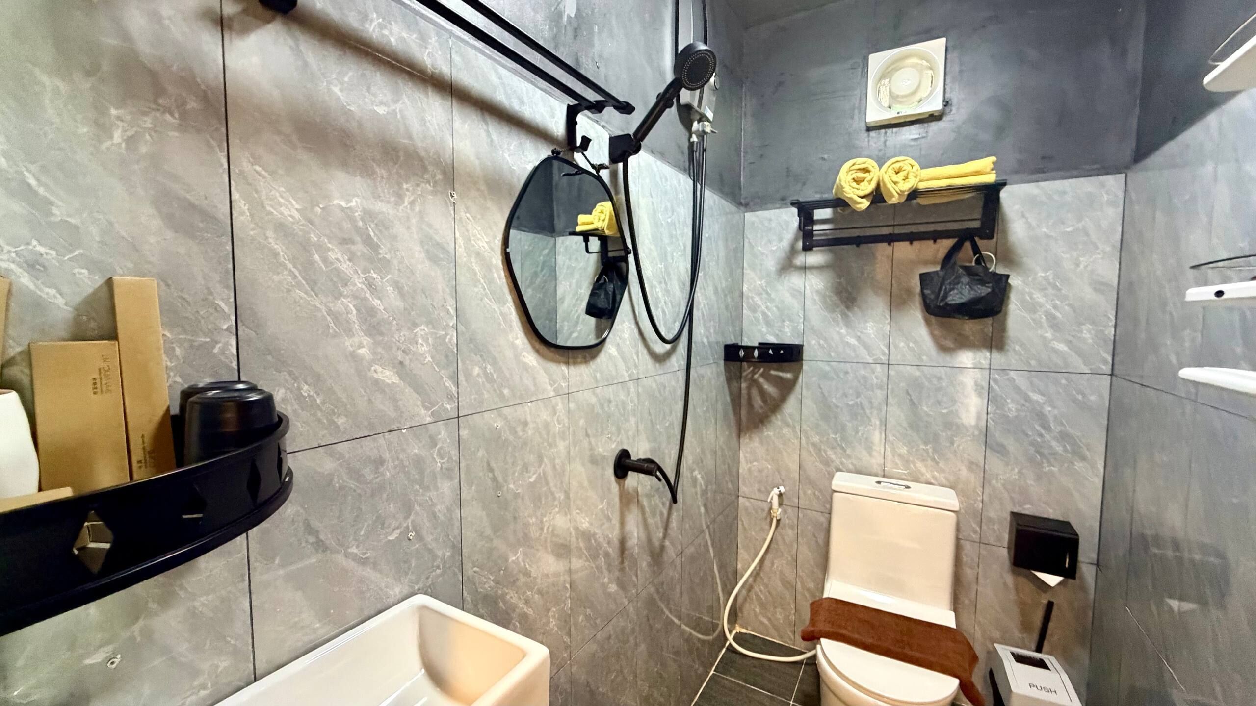 A modern bathroom with a toilet, bidet, and shower.