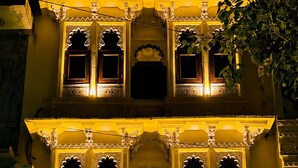 A hotel entrance with a sign reading 'HOTEL MOXA INN,' ornate architectural details, and a red carpet leading to the door. - Hotel Moxa Inn (Udaipur)