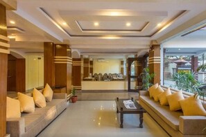 A hotel lobby with a reception desk, seating areas, and a coffee table. - Devo Boutique Hotel (Kathmandu)