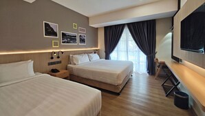 A hotel room with two beds, a TV, a desk, and a window with curtains. - Raia Beach Resort Port Dickson (Port Dickson)