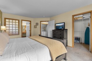 A bedroom with a bed, dresser, TV, closet, and a window with a view. - New! Eagle Crest Retreat | 3BR Townhome w/ Resort Access—Pet Friendly (Redmond)