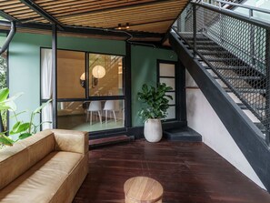 A modern interior with a wooden ceiling, a staircase, a sofa, and a potted plant. - w Charming 2BR w Terrace Jacuzzi in Poblado (Medellín)