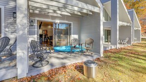 A house with a covered porch, outdoor seating, and a visible garage door. - Steps to Lake Tanglwood: Tranquil Wooded Retreat (Greentown)