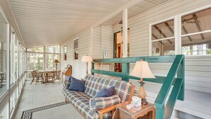 A cozy room with a plaid sofa, a wooden table, and a lamp. - Clark's Hill Lake Retreat! Waterfront Home w/ Dock (Modoc)