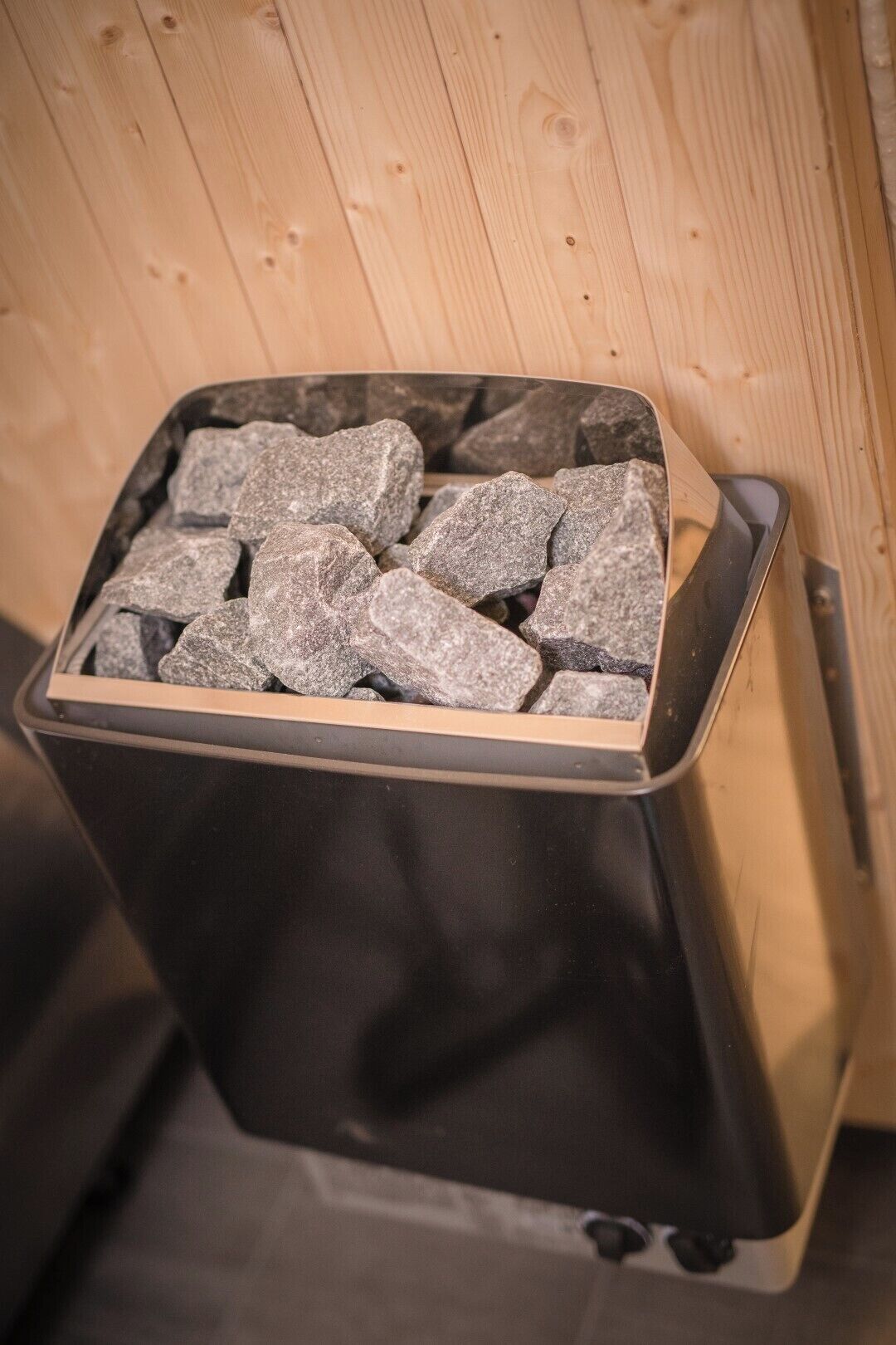 A trash bin filled with rocks.