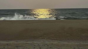 A beach with the sun reflecting on the water. - Beachwalk 20, Steps to the Beach, Outdoor Pool (Ocean City)