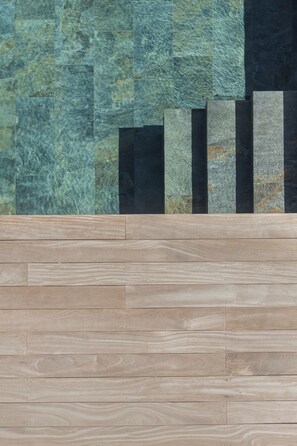 A wooden floor with a stone wall in the background. - Villa Tonka (Oyster Pond)