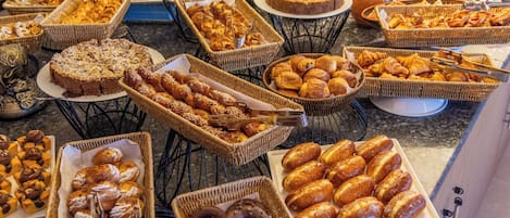 Un bufé con diversos productos horneados y repostería.