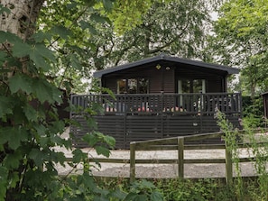 A cabin with a deck, surrounded by trees. - Watendlath (Keswick)