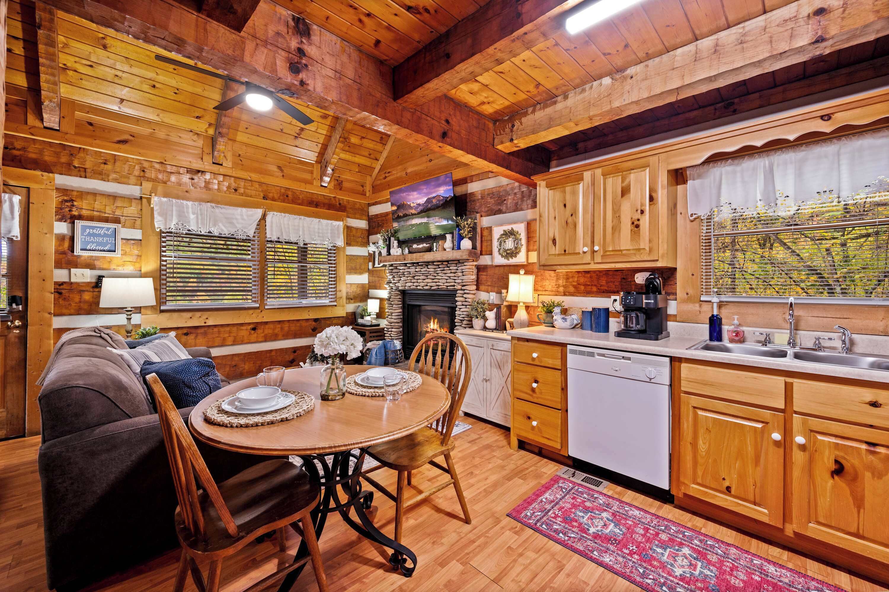 A cozy cabin-style interior with a dining area, kitchen, and living space.
