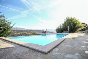 A swimming pool with a clear view of the surrounding landscape, including mountains and trees. - Bosque da Fantasia (Baiao)