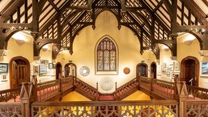 A grand hall with a high ceiling, wooden beams, and a large stained glass window. - Glyn y Weddw - sleeps 8 guests  in 4 bedrooms (Llanbedrog)