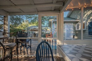 A covered patio with a dining table and chairs, a bench, and a view of the backyard. - 2 Step: Pool, Hot Tub and Dog-Friendly (Oak Island)