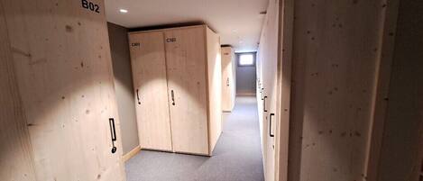 A hallway with wooden lockers labeled B02, C401, and C303.