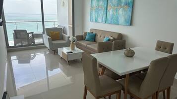 Superior Apartment, Beach View | Living area | 50-inch Smart TV with digital channels