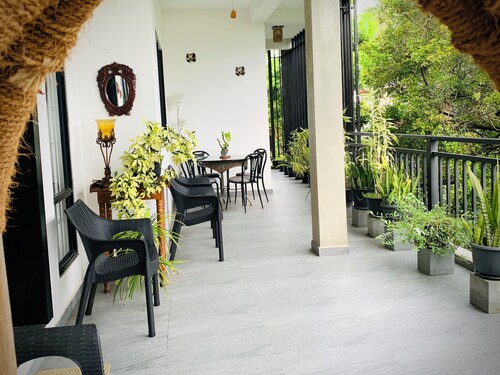 Modern 2-Bedroom Apartment in a Secure Gated Residence surrounded by trees.