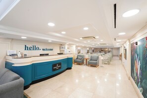 A hotel reception area with a blue counter, a 'hello welcome' sign, and a reception desk. - Taksim Stare Hotel (Istanbul)