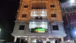 A building with a sign reading "P.P. PALACE" and a balcony with string lights. - PP Palace (Puri)
