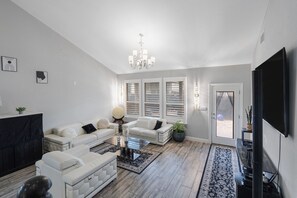 🛋 Living Room  “Cathedral ceilings, leather seating, and vibes that feel like vacation.” - Domain-side: Cathedral-ceiling, Game Room, Karaoke (Austin)