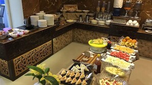 A buffet setup with various food items and condiments. - Hotel Buddy (Kathmandu)
