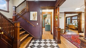 A staircase with wooden railings leading to a dining area with a red carpet. - Gorgeous private home! Central Air 4 beds, hot tub, patio, designer furnishings (Portland)
