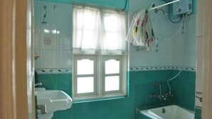 A bathroom with a window, a sink, and a bathtub. - Bliss Apartment (Kathmandu)