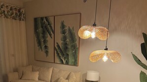 A dining area with a round table, wooden chairs, and a hanging light fixture. - Beauty Apartment Dominicus Breeze (Dominicus)