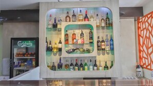 A bar area with shelves of liquor bottles and a visible Carlsberg refrigerator. - Hotel Marinha Pvt. Ltd (Kathmandu)