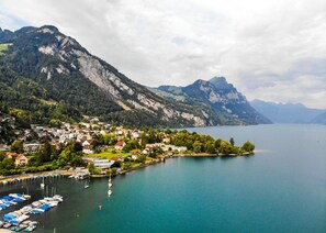 A lakeside town with a marina, houses, and mountains in the background. - ReMo I Old town idyll on Lake Walen #1 | Mountain (Weesen)