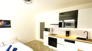 A compact kitchen with white cabinets, a microwave, a coffee maker, and a sink. - Apartment 10 min walk to center (Jihomoravský kraj)