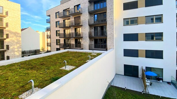 A modern apartment building with multiple balconies, a rooftop garden, and a covered outdoor seating area. - Apartment 10 min walk to center (Jihomoravský kraj)