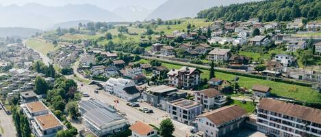 Vista aérea de una zona residencial con casas, caminos y una montaña al fondo.