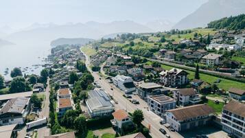 An aerial view of a coastal town with residential buildings, roads, and a marina.