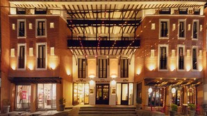 A hotel with a brick facade, a covered entrance, and a ground-level retail space. - Hotel Roadhouse (Kathmandu)