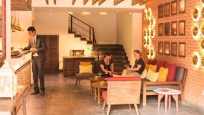 A modern interior with a bar area, seating, and a staircase. - Hotel Roadhouse (Kathmandu)