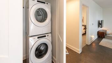 A laundry room with two stacked Whirlpool front-loading washers.
