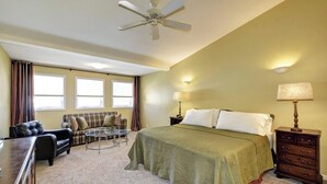 A bedroom with a bed, a desk, a chair, a sofa, and a nightstand. - Charming Townhouse in Louisville – Explore the Urban Oasis! (Louisville)